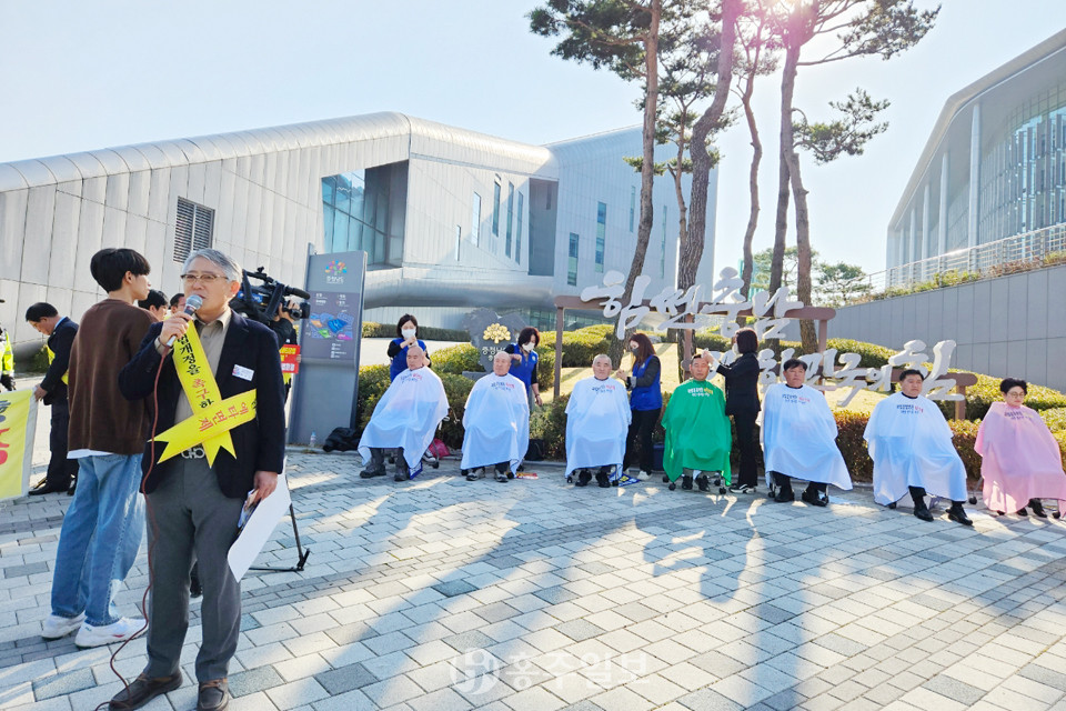 충남도 청사 앞 200여 명 집회 중 9명이 예비타당성조사 면제 반대 시위를 위한 삭발식을 행하고 있다.