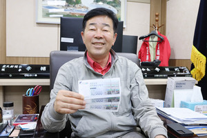 이보형 광천농업협동조합장이 발행을 앞둔 광천농협 지역희망상품권을 들어보이며 미소짓고 있다.