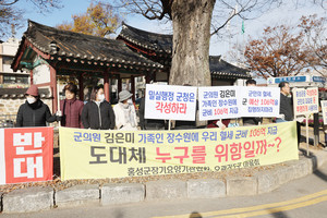 홍성군 내 요양기관 종사자로 구성된 홍성군장기요양기관협회 회원들과 공공 치매전담형 노인요양시설이 신축될 홍성읍 오관리5구 마을주민들이 지난 19일 오전 홍성군청 앞에서 사업관련 의혹 해소를 요구하며 건립 반대 시위를 하고 있다.